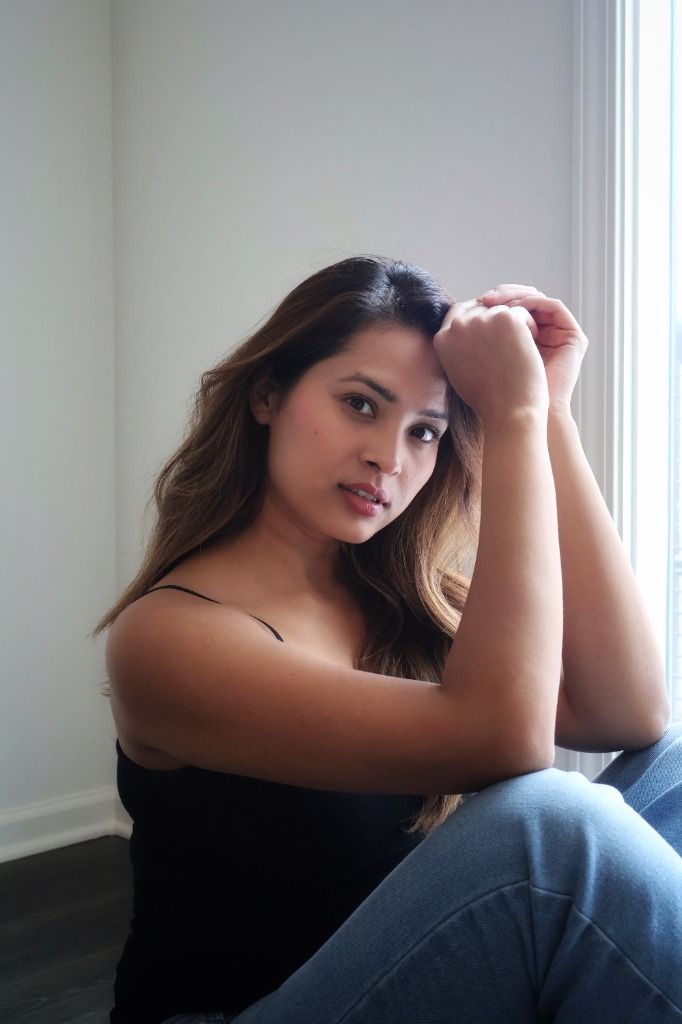 Alina Roy by a window